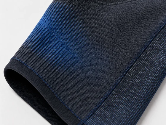 Annotated gradient-knit and zoned-panel compression construction cutaway